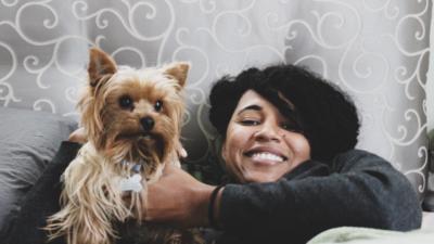 woman and her dog hanging out in bed